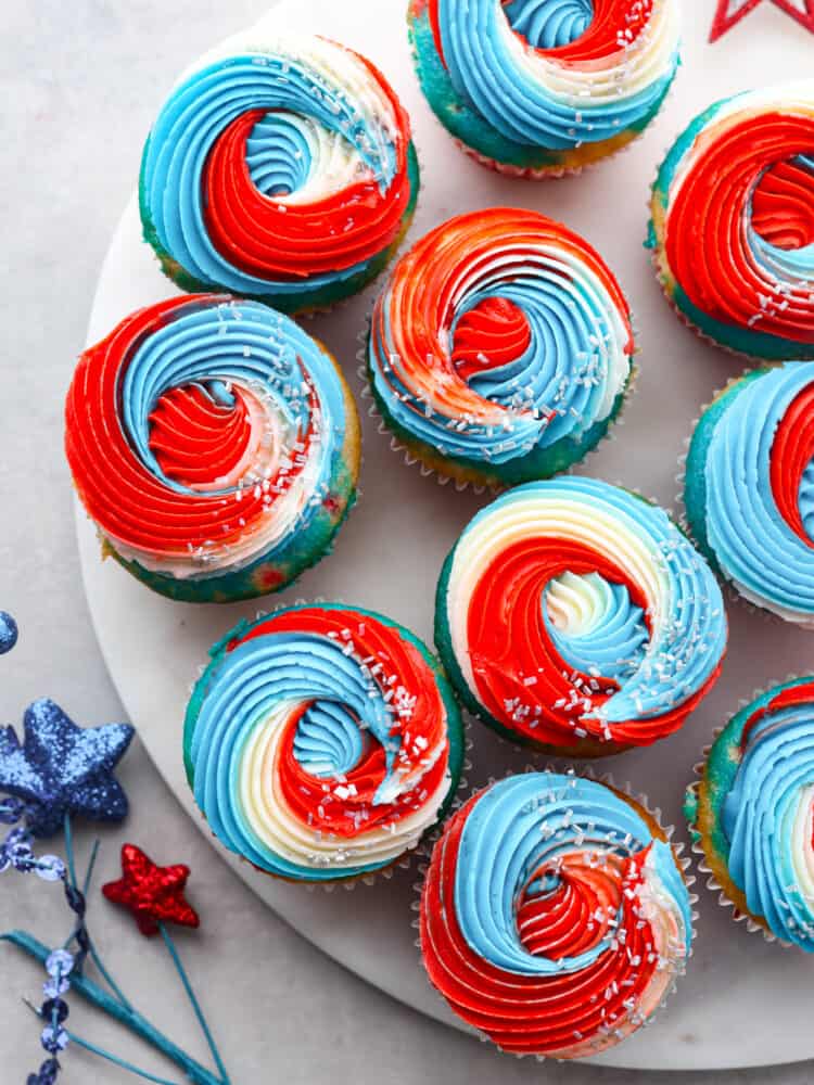 The top view of red, white and blue cupcakes on a marble platter. 