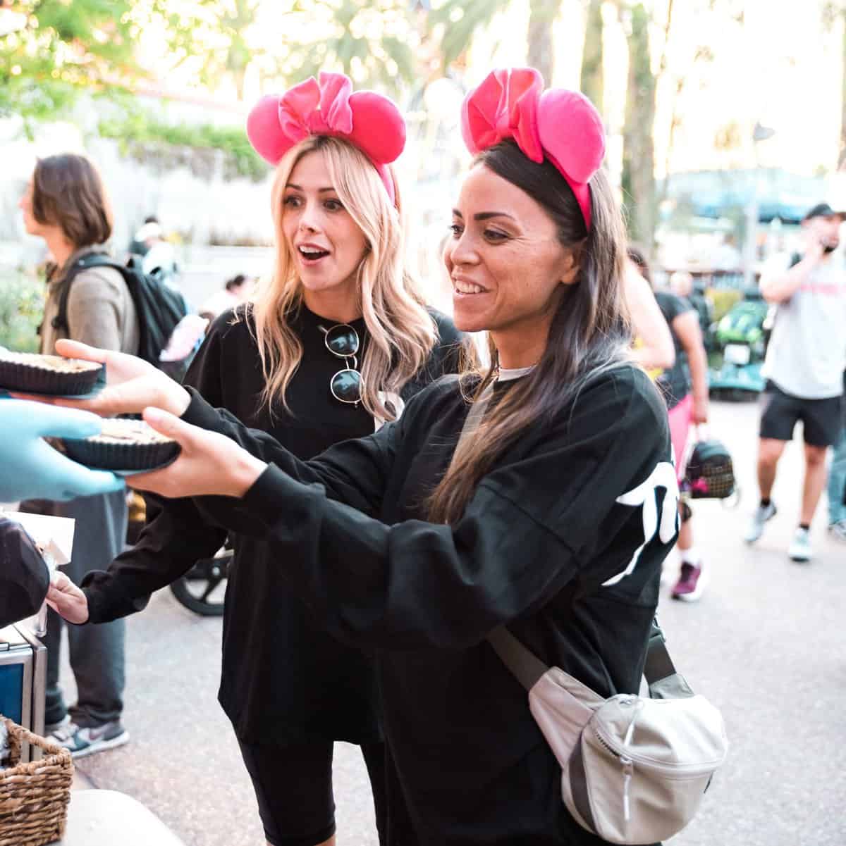 2 women getting a Jack Jack Cookie at California Adventure. 