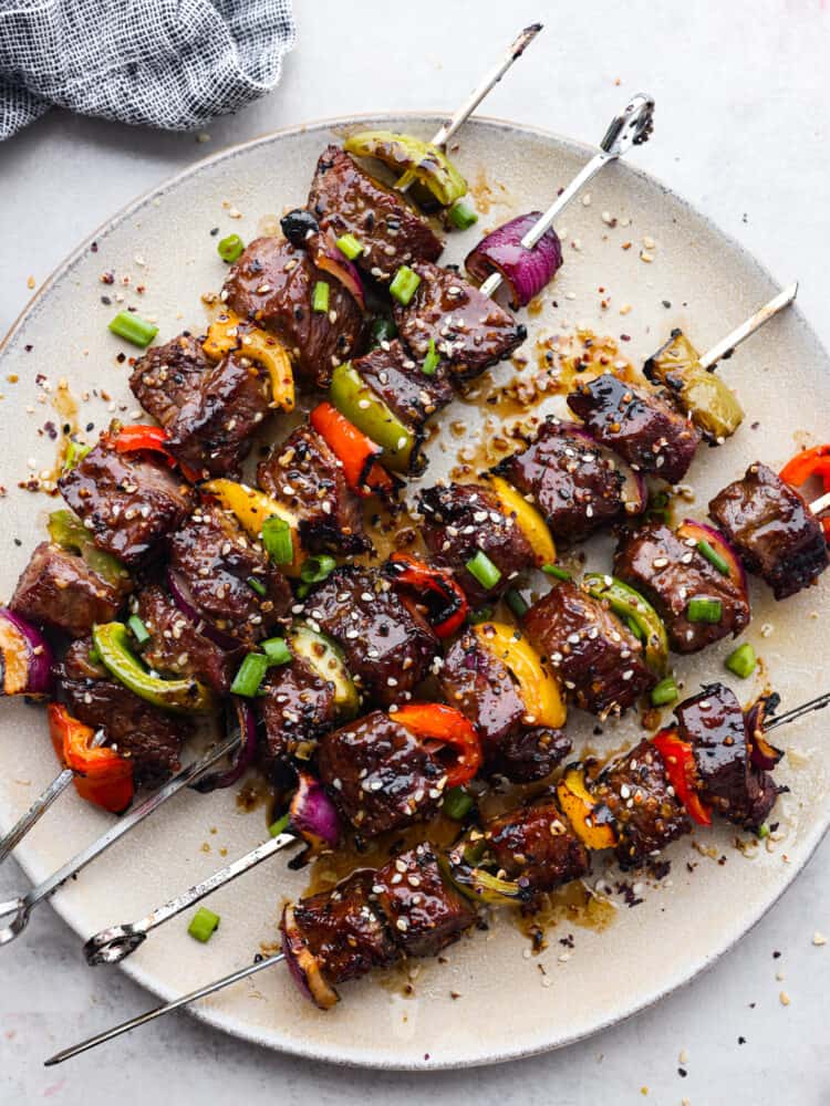 Asian Grilled Garlic Steak Skewers cooked and on a plate.