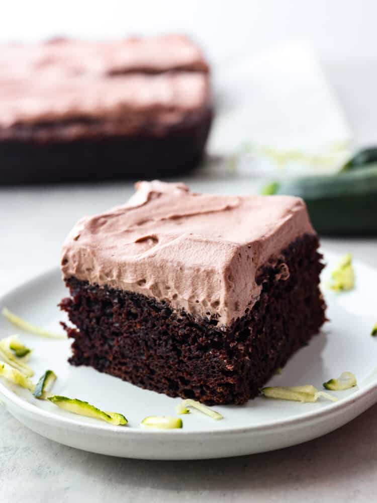 A slice of chocolate zucchini cake on a plate. 