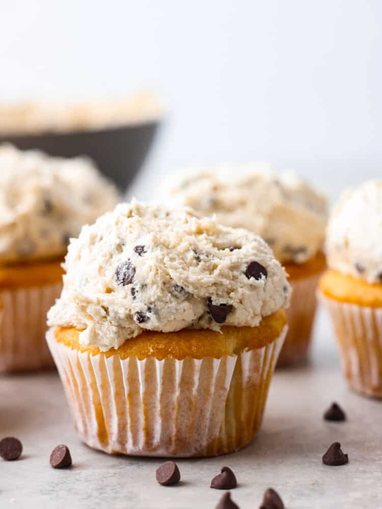 Closeup of a cupcake topped with cookie dough frosting.