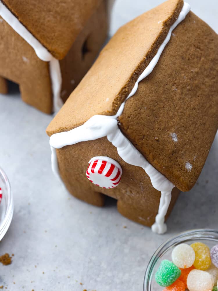 A top view of a gingerbread house with a peppermint candy on the front.