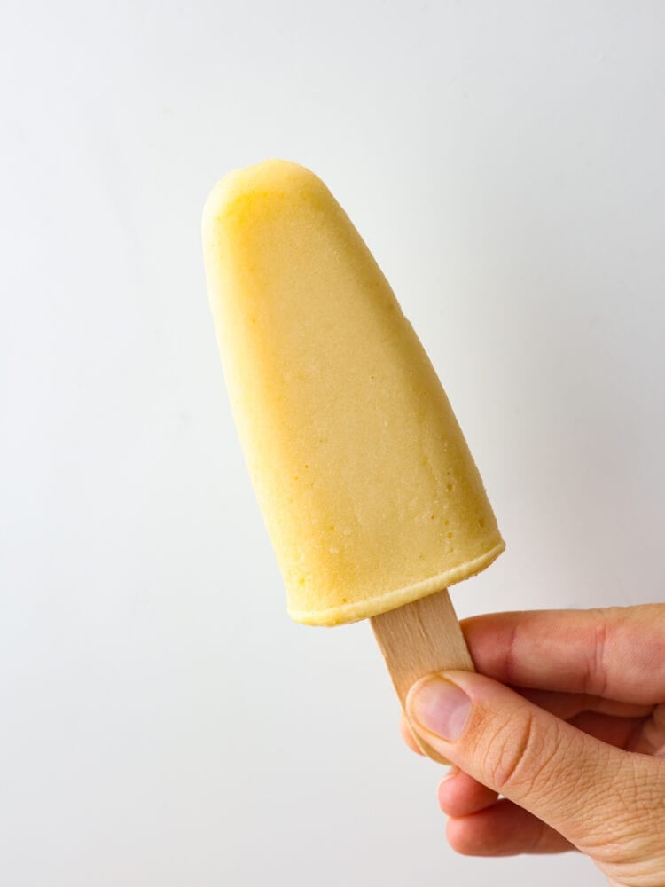 Closeup of a yellow popsicle.