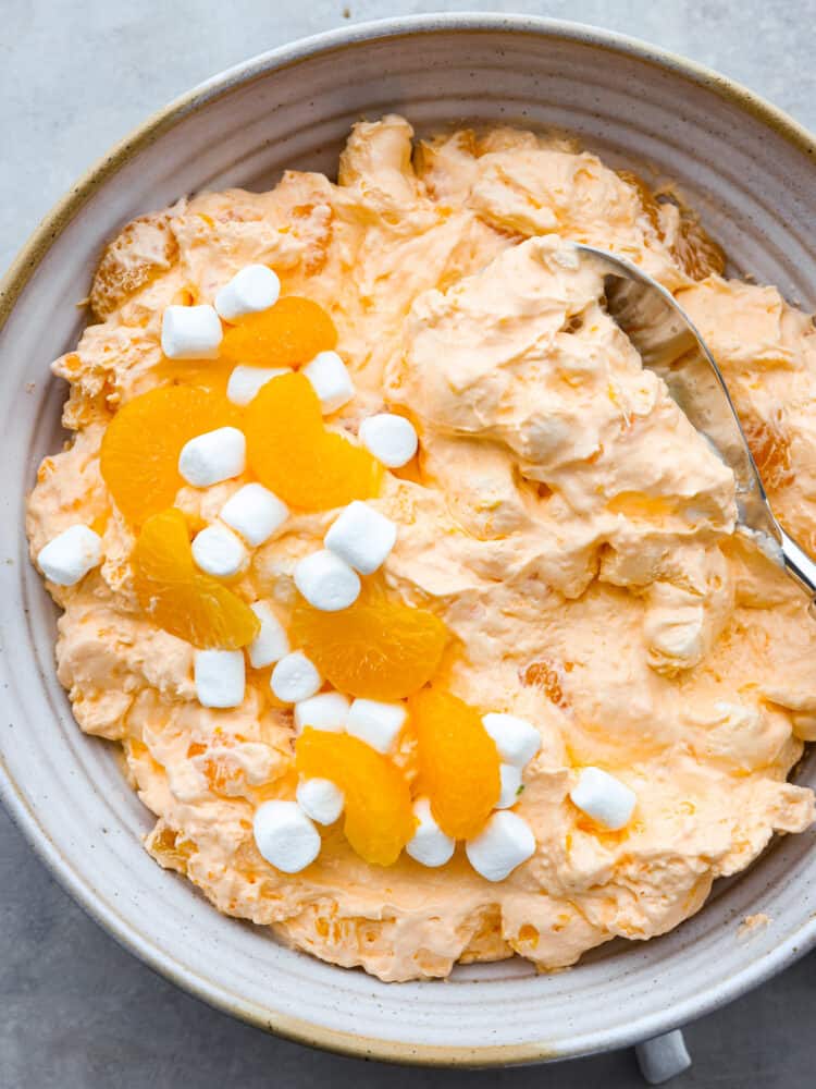 The top view of a bowl of orange creamsicle salad. 