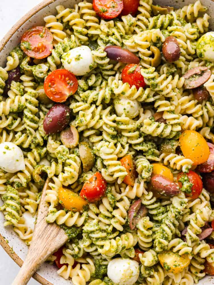 A zoomed in shot of the top of pesto pasta salad. 