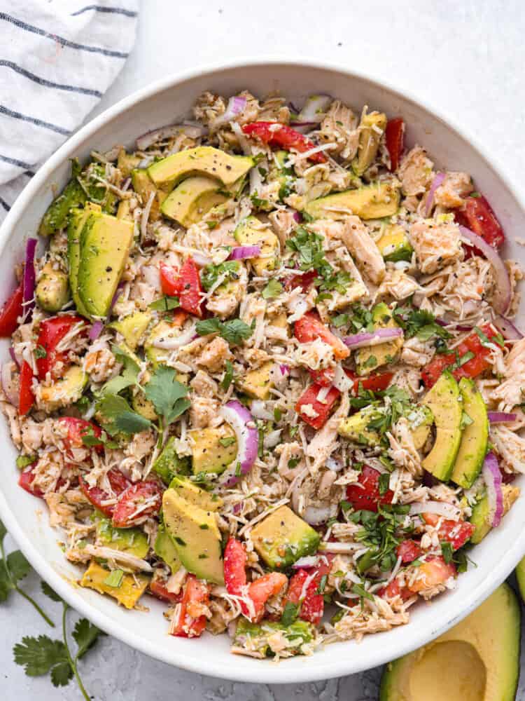 Top-down view of tuna salad in a white bowl.