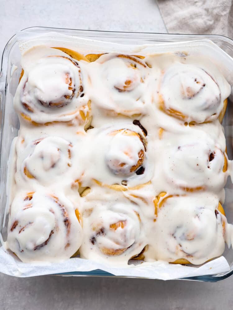 The top view of 45-minute cinnamon rolls, baked and in a pan with a glaze on top. 