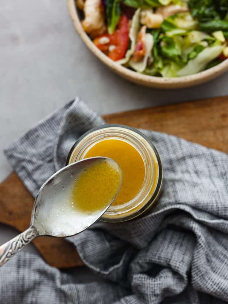Top-down view of a spoonful of apple cider vinaigrette.