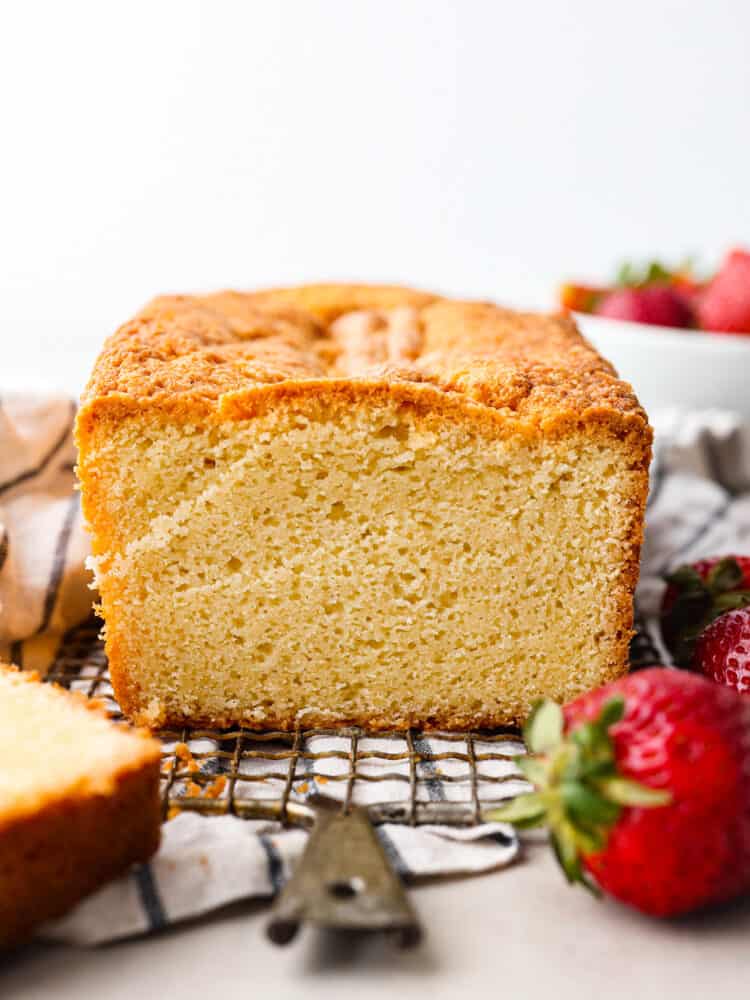 A loaf of pound cake sitting on a wire rack.