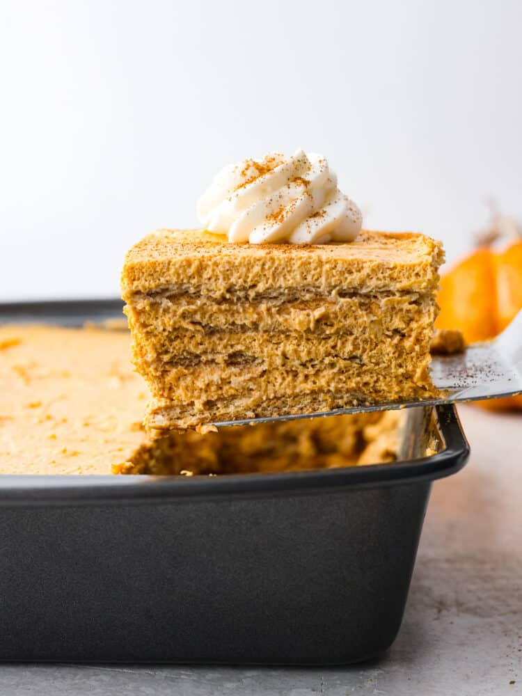 A slice of pumpkin icebox cake being served out of the baking dish. 