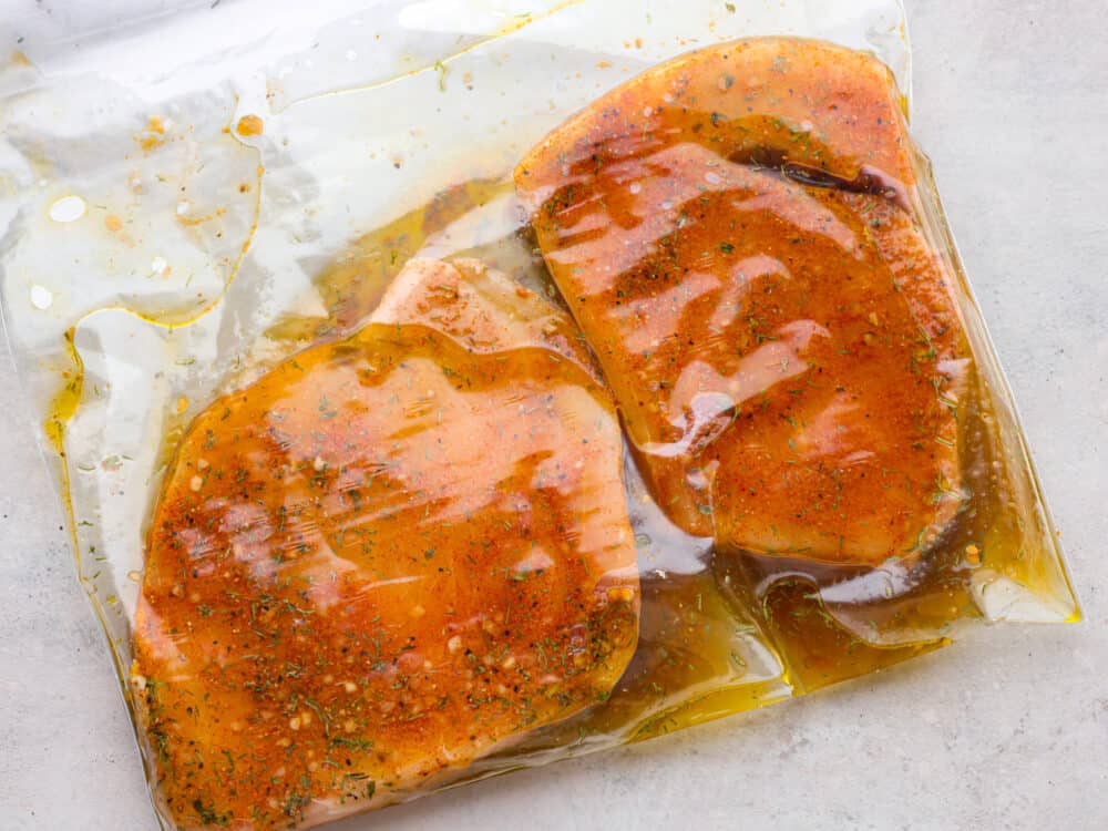 Marinating swordfish steaks in a ziplock bag.