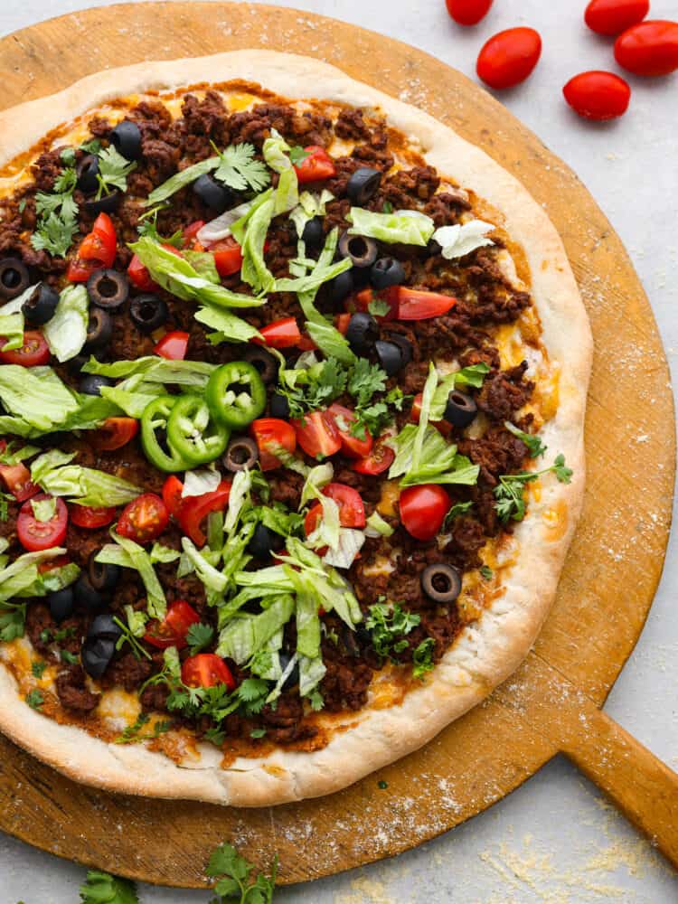 Top-down view of a whole taco pizza.