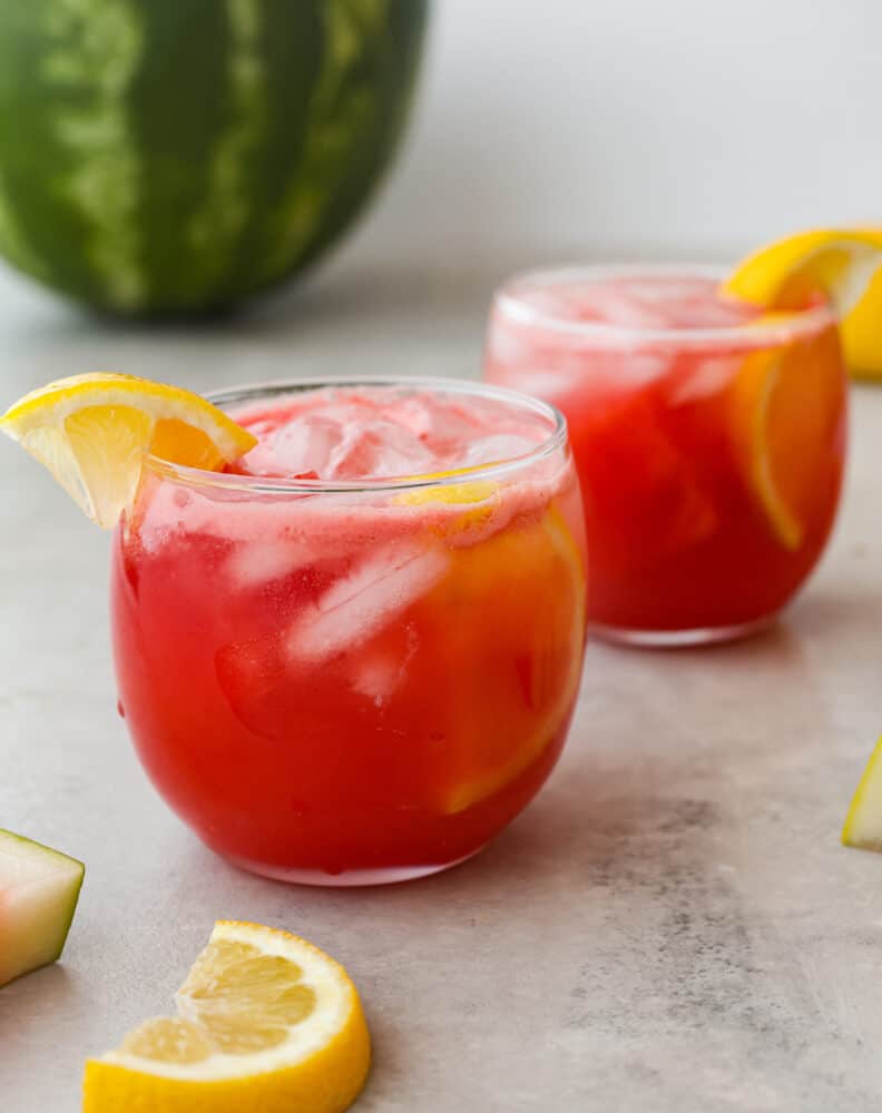 2 glass cups filled with watermelon lemonade.