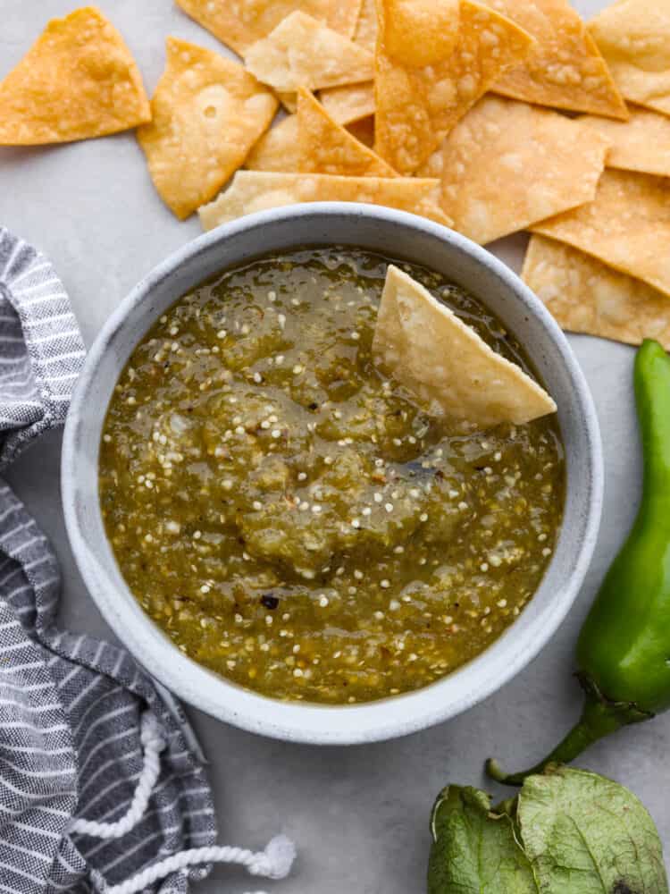 Top-down view of tomatillo salsa served in a white bowl.