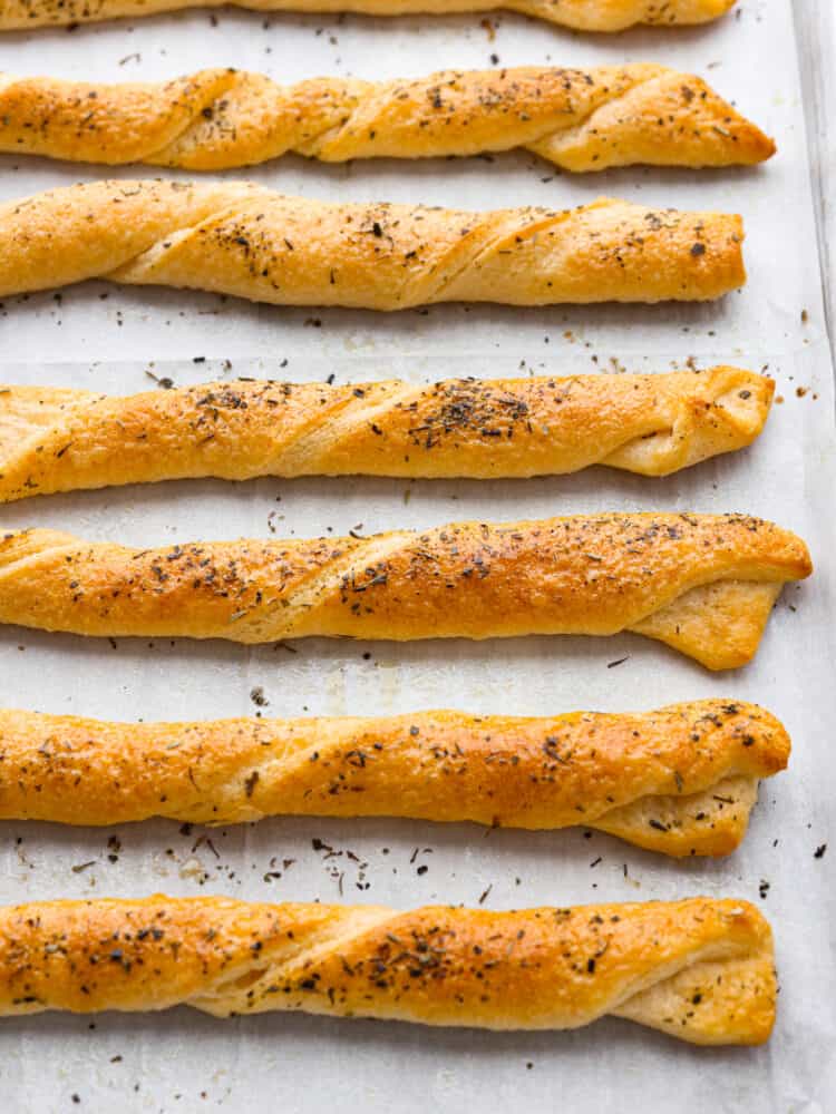 Cooked Italian bread twists on a baking sheet with parchment paper. 