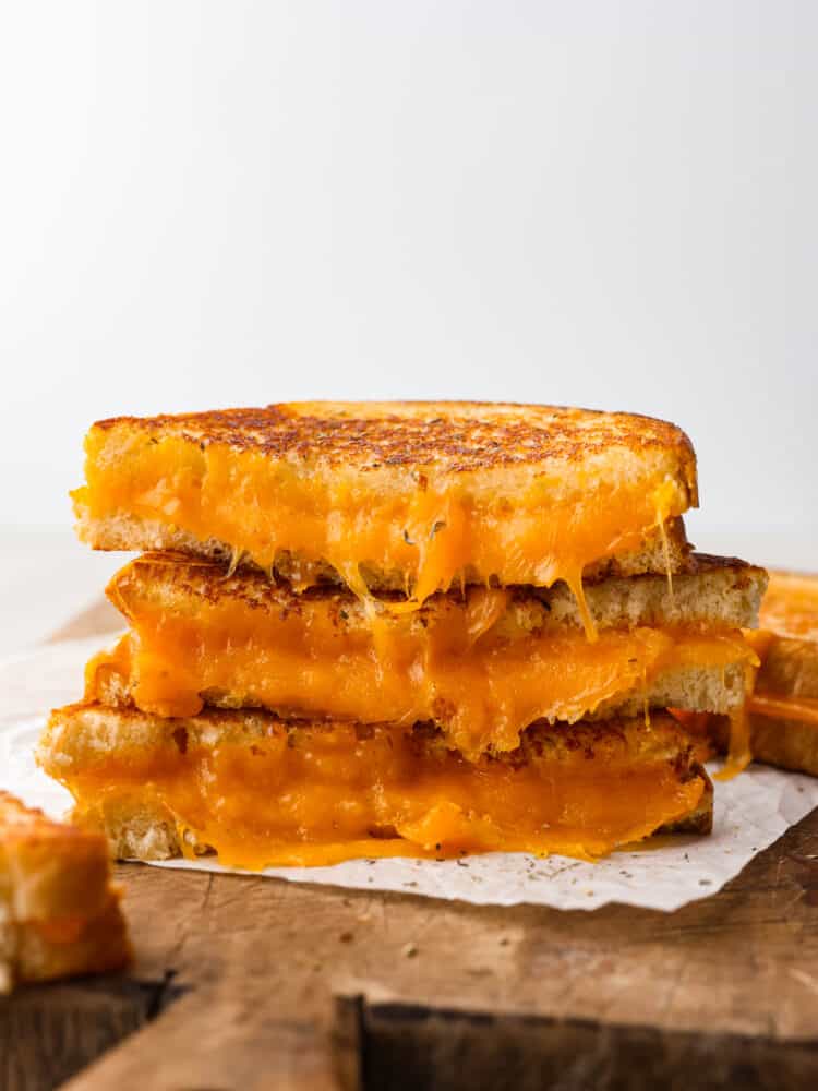 A stack of slices of grilled cheese sandwich. 
