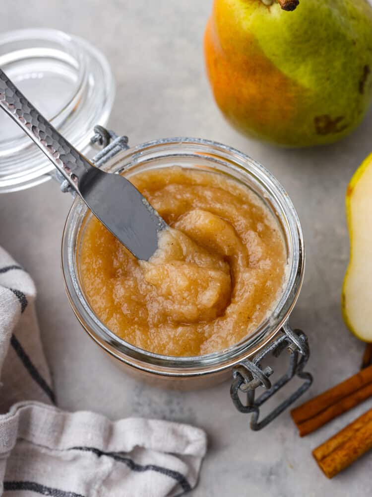 Top down view of pear butter in a glass jar.