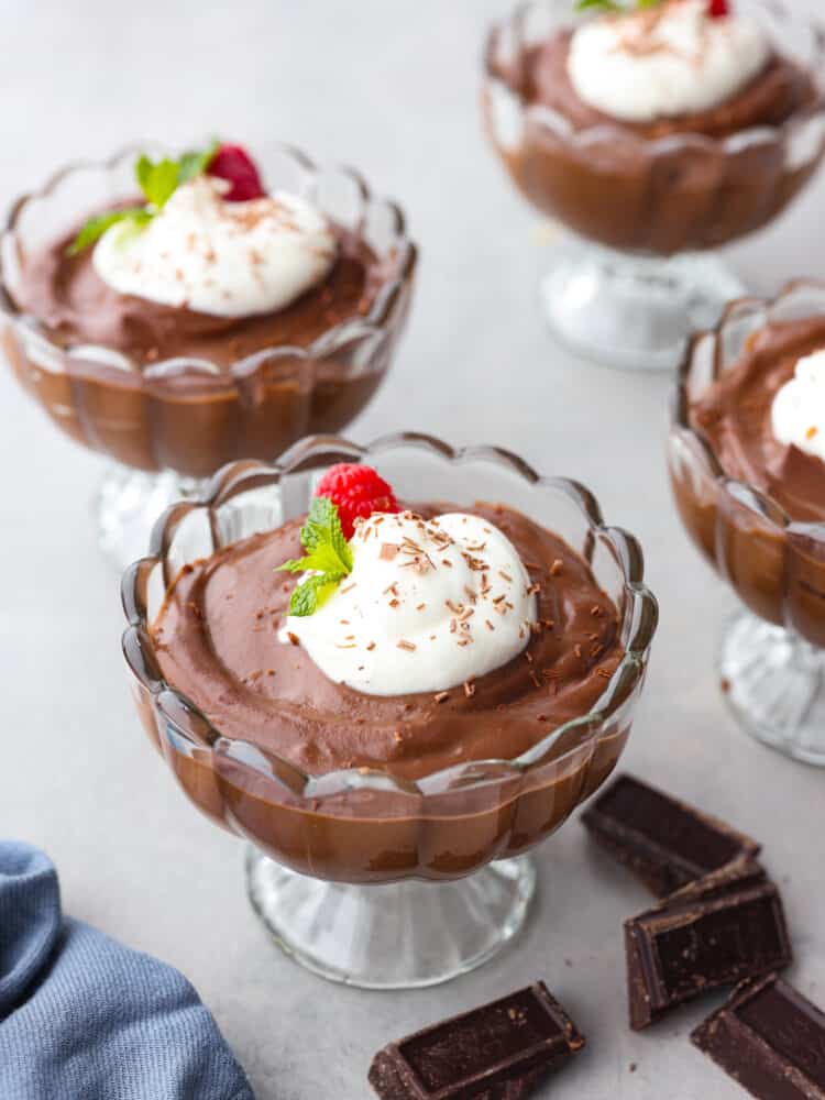 Multiple glass jars filled with homemade chocolate pudding.