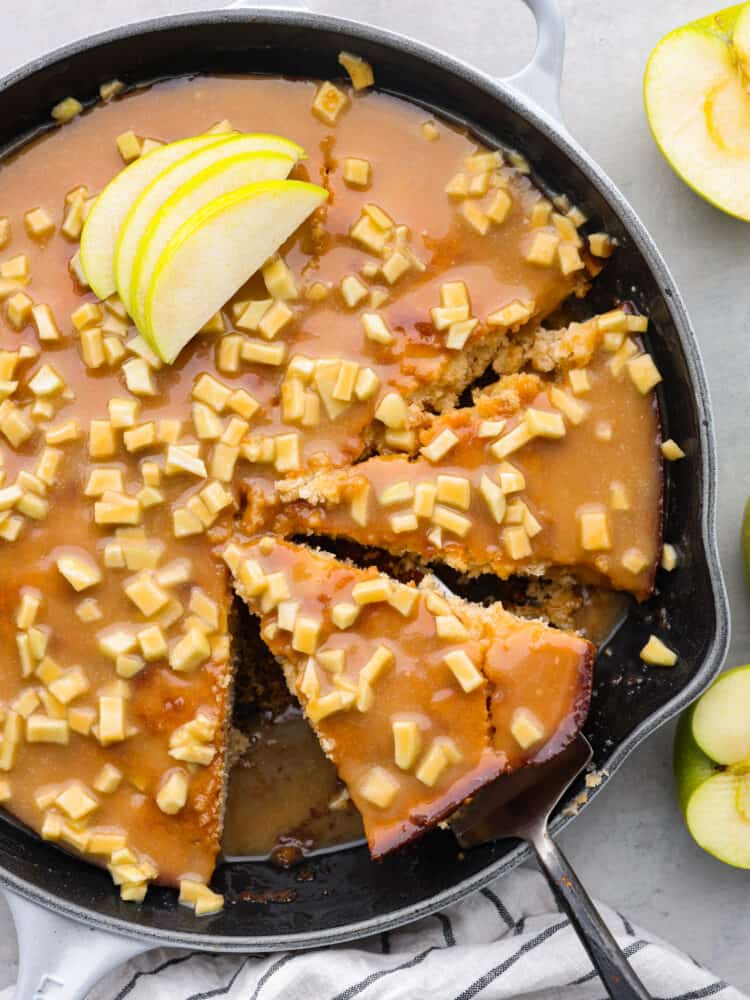 Top-down view of caramel apple skillet cake, cut into slices.