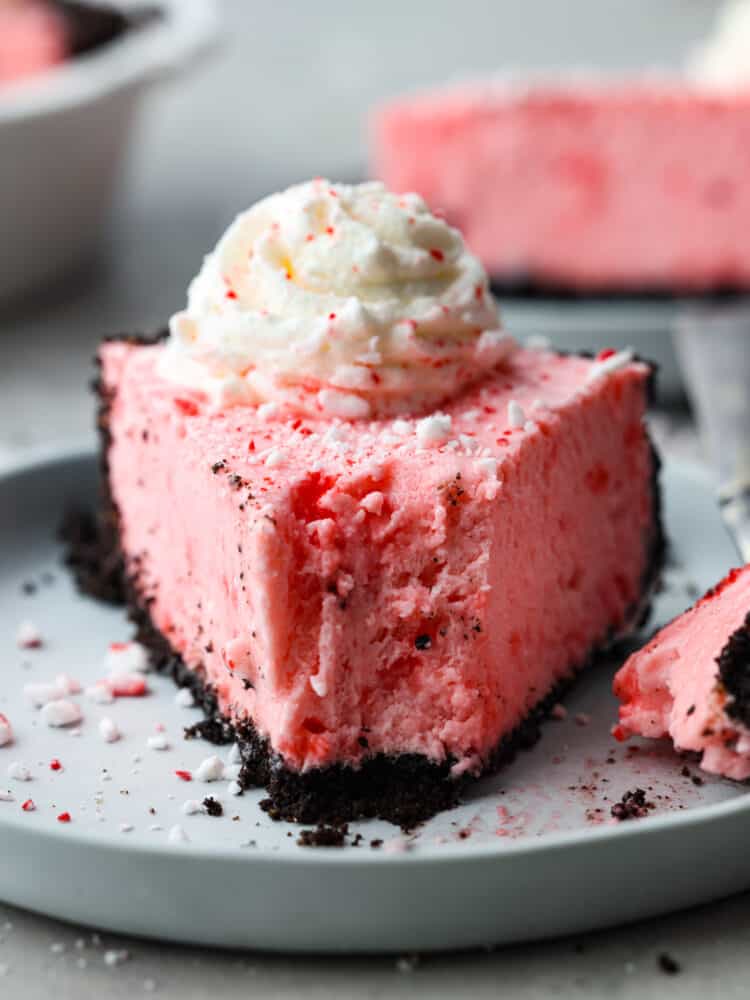 A slice of peppermint pie with a bite taken out of it. 