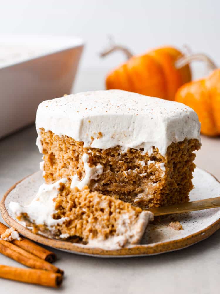 A slice of pumpkin tres leches with a bite taken out of it.