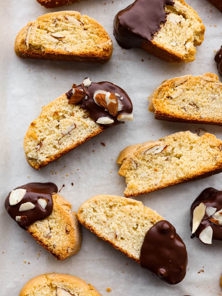 A close up of classic biscotti dipped in chocolate with almonds on top.