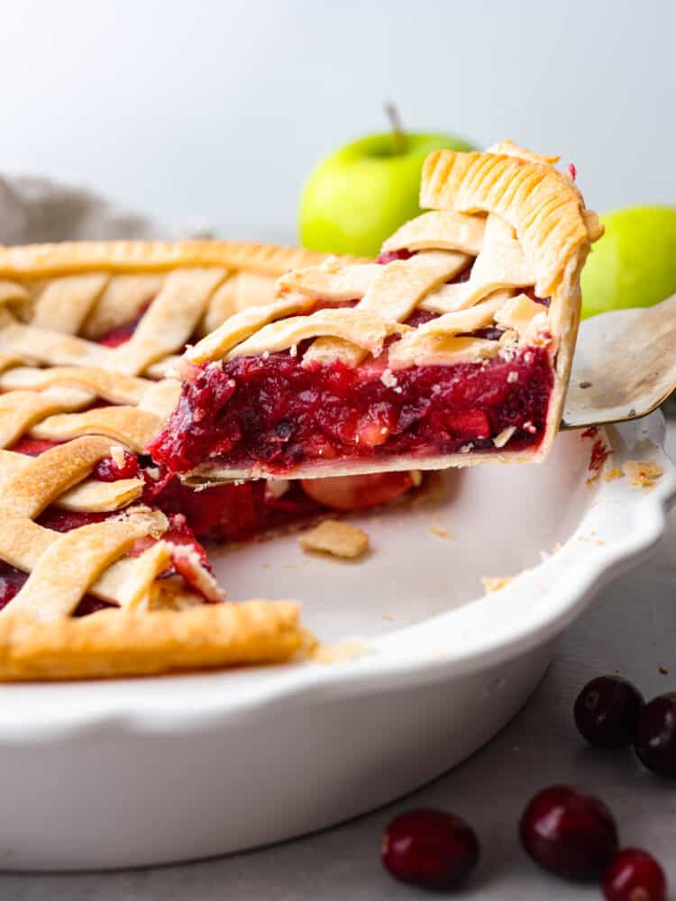 A slice of cranberry world pie stuff served with a confection spatula.