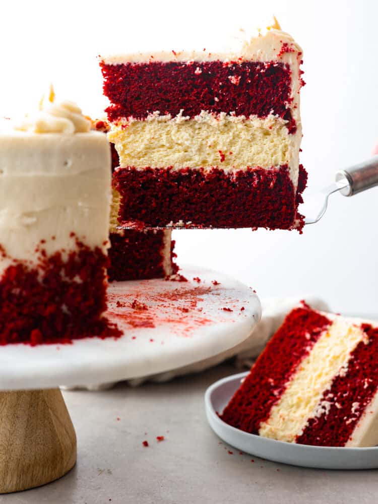 Hero image of a slice of red velvet cheesecake being served with a cake spatula.