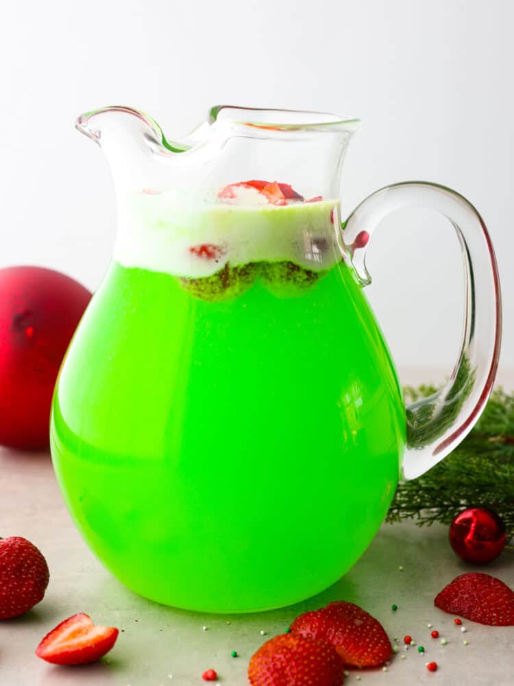 Green punch in a large glass pitcher.
