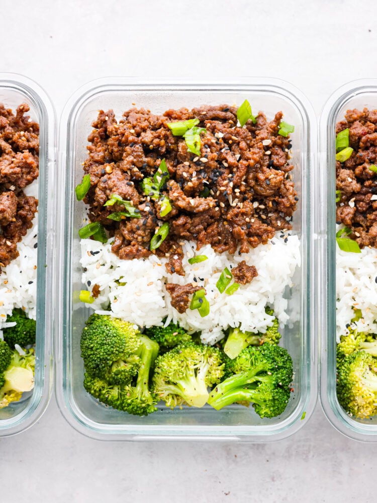 Top-down view of Korean beef served with rice and broccoli in plastic containers.