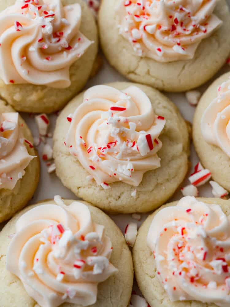 Close up view of peppermint meltaways with frosting and sprinkled peppermint candy on top.
