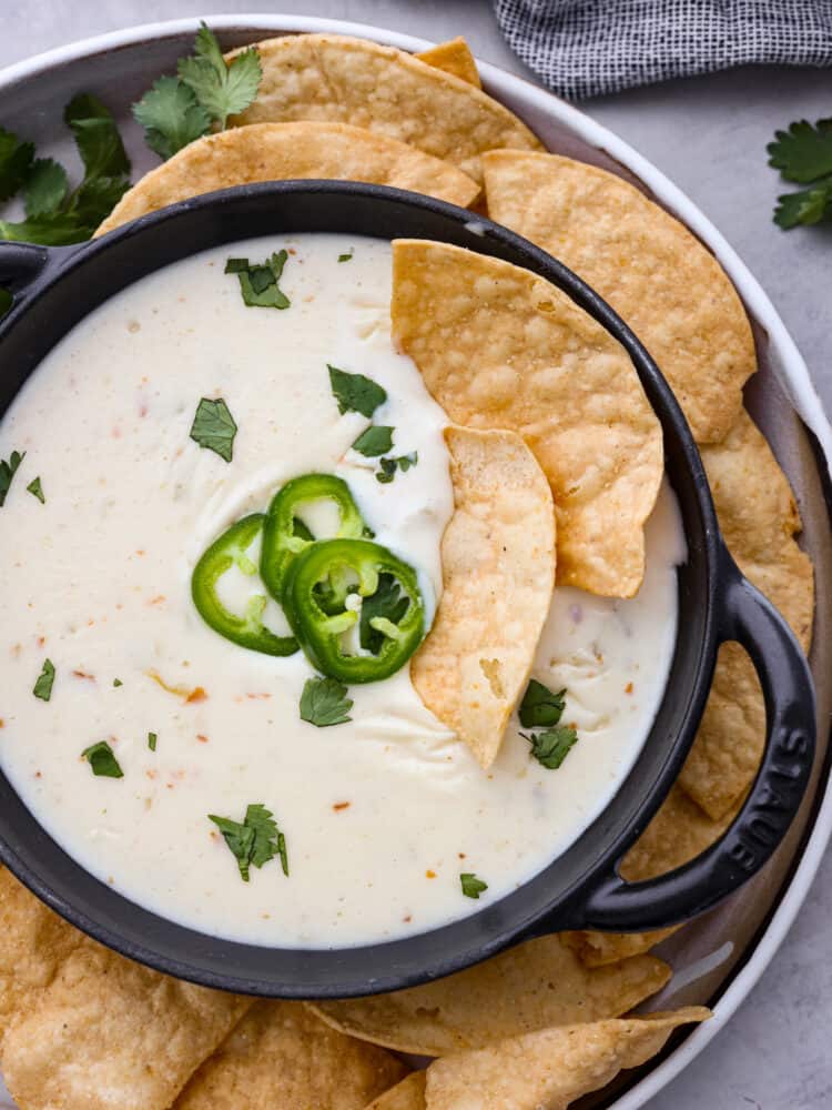 The dip in a bowl with a few chips sticking out of it.