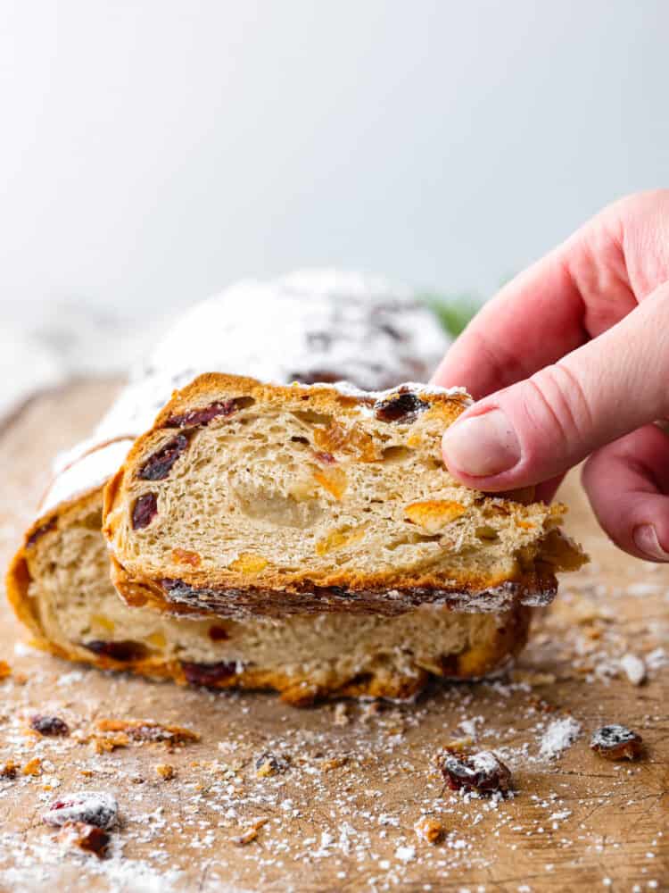 Front view of stollen with a slice being picked up.