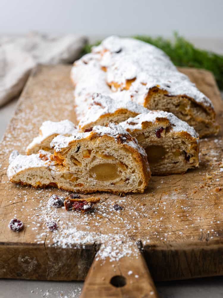 Hero image of sliced stollen bread on a wooden board.