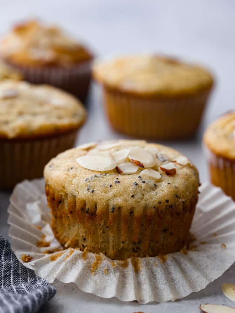 An almond poppy seed muffin with the cupcake liner unwrapped.