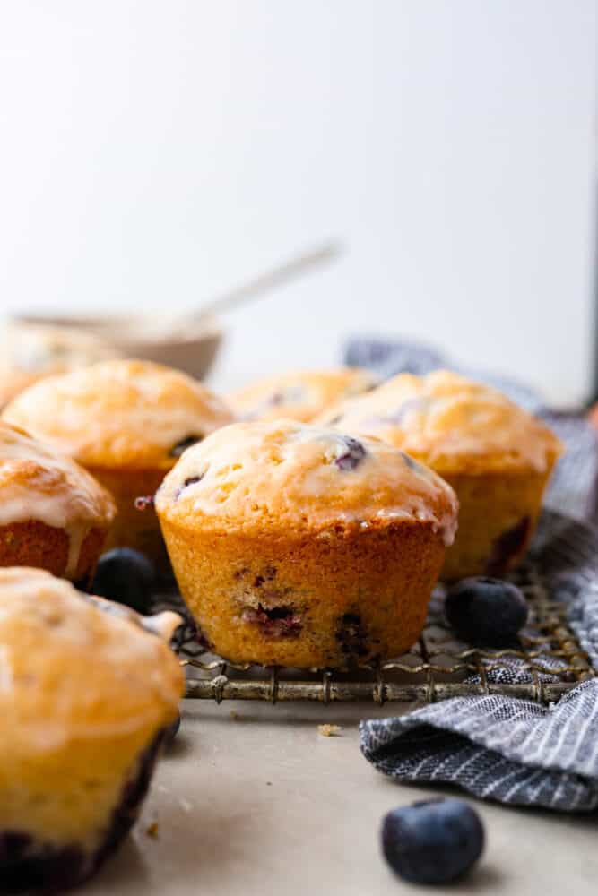 Hero image of blueberry muffins on a wire rack.