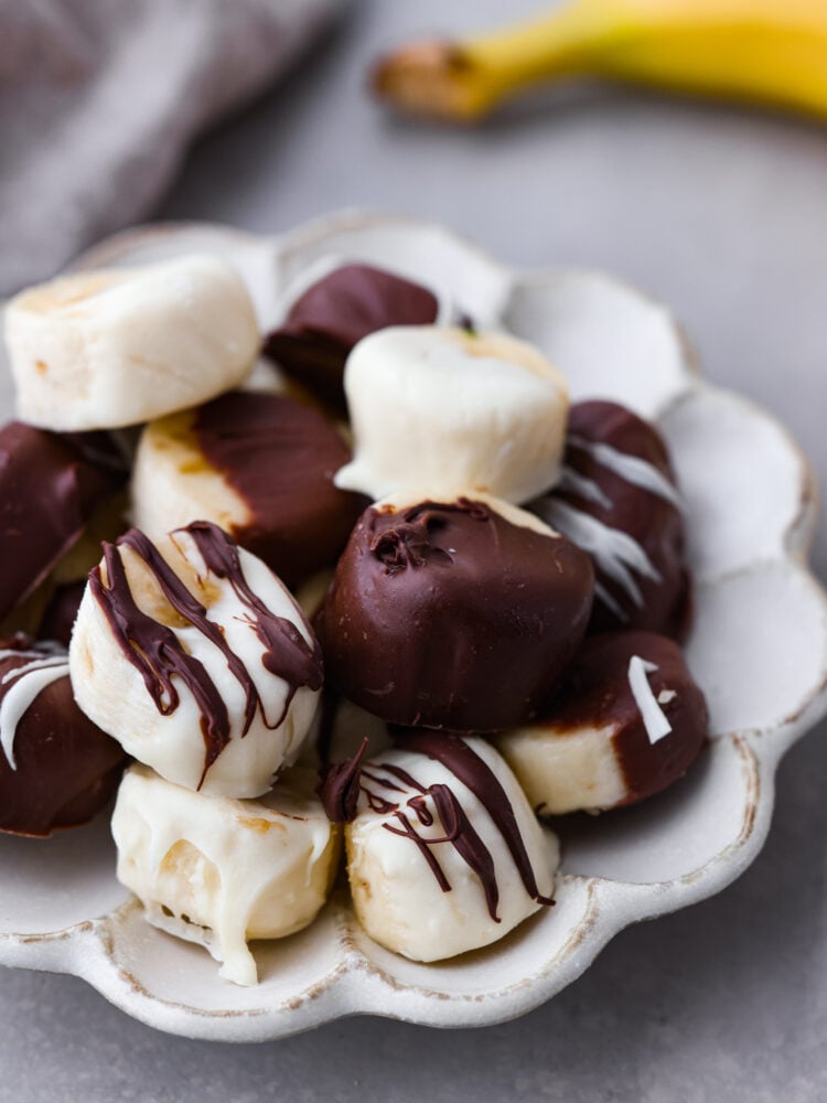 Chokladdoppade bananer serveras på en vit skålad skål.