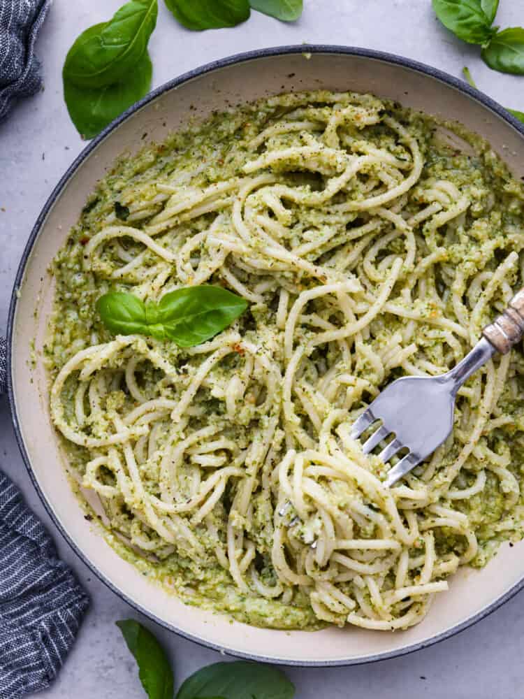 A bowl of pasta with creamy pesto on top.