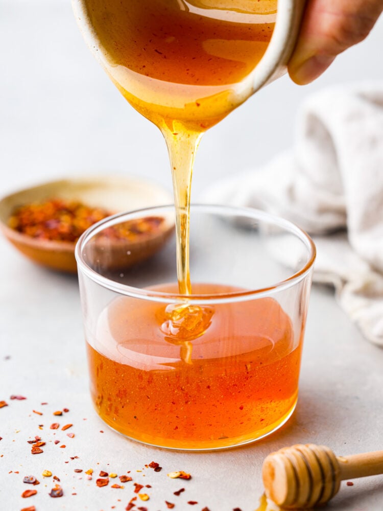 Hot honey being poured into a container.