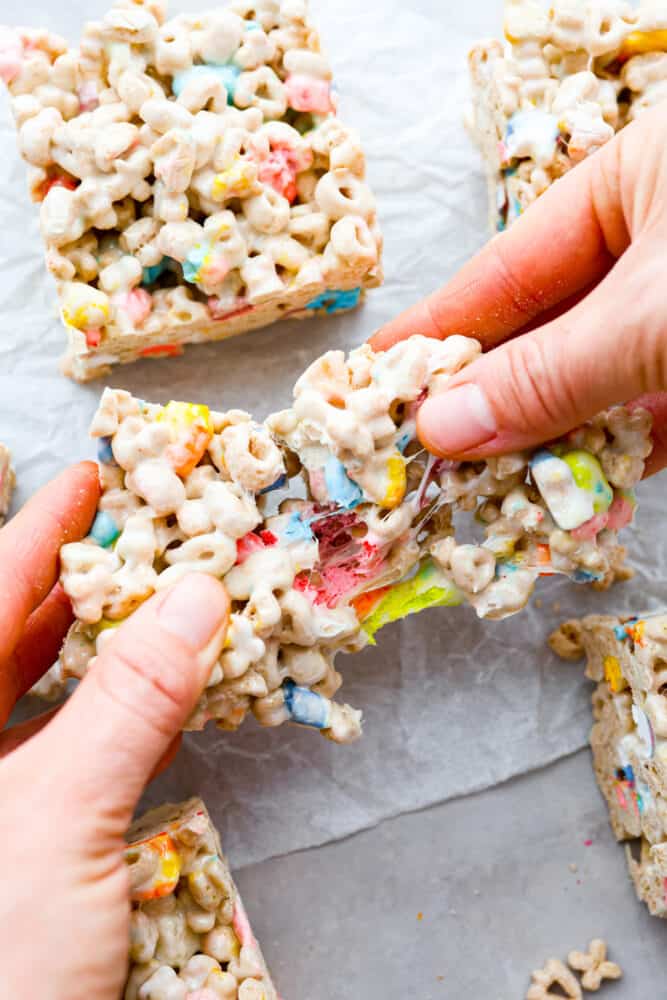 A hand pulling apart the cereal bars.