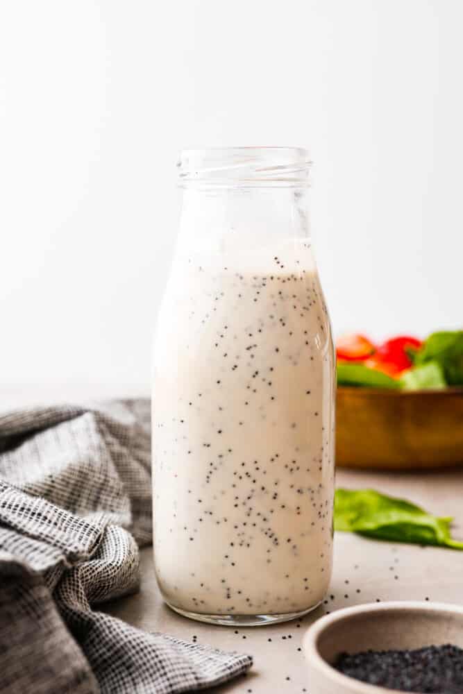 Creamy poppyseed dressing in a glass jar.