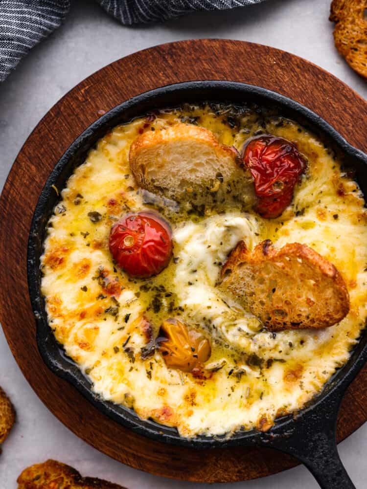 Top-down view of provoleta in a small skillet.