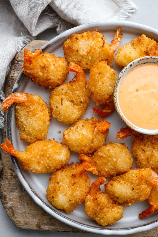 Cooked, breaded shrimp served on a gray plate.