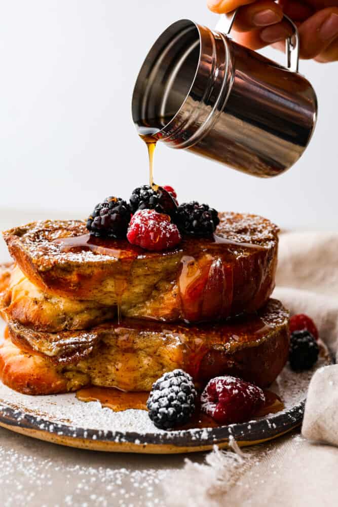 Syrup being poured over French toast.