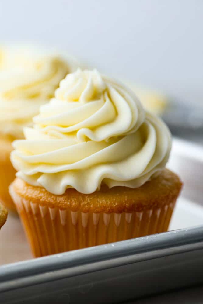 Closeup of a cupcake topped with buttercream frosting.