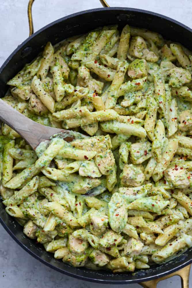 A close up of the pesto pasta in the pan.