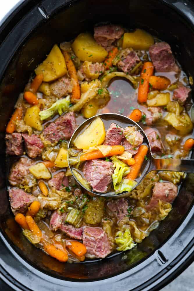Corned beef and cabbage stew in a slow cooker.