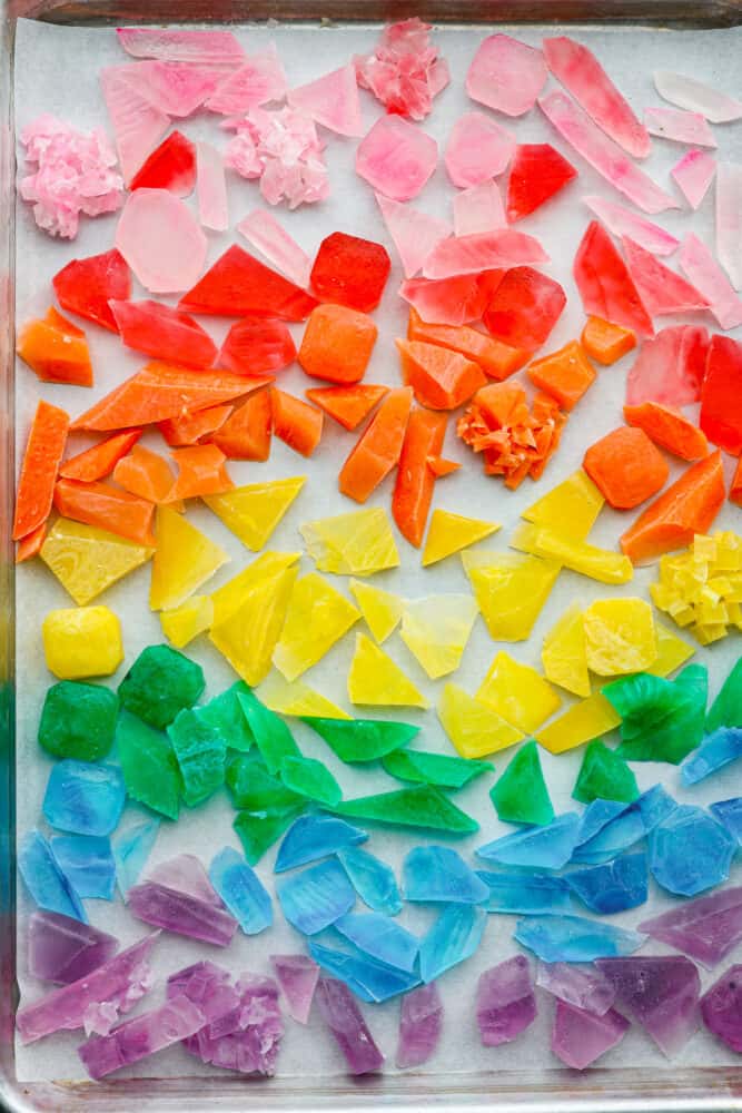 Top-down view of crystal candy on a baking sheet with parchment paper.