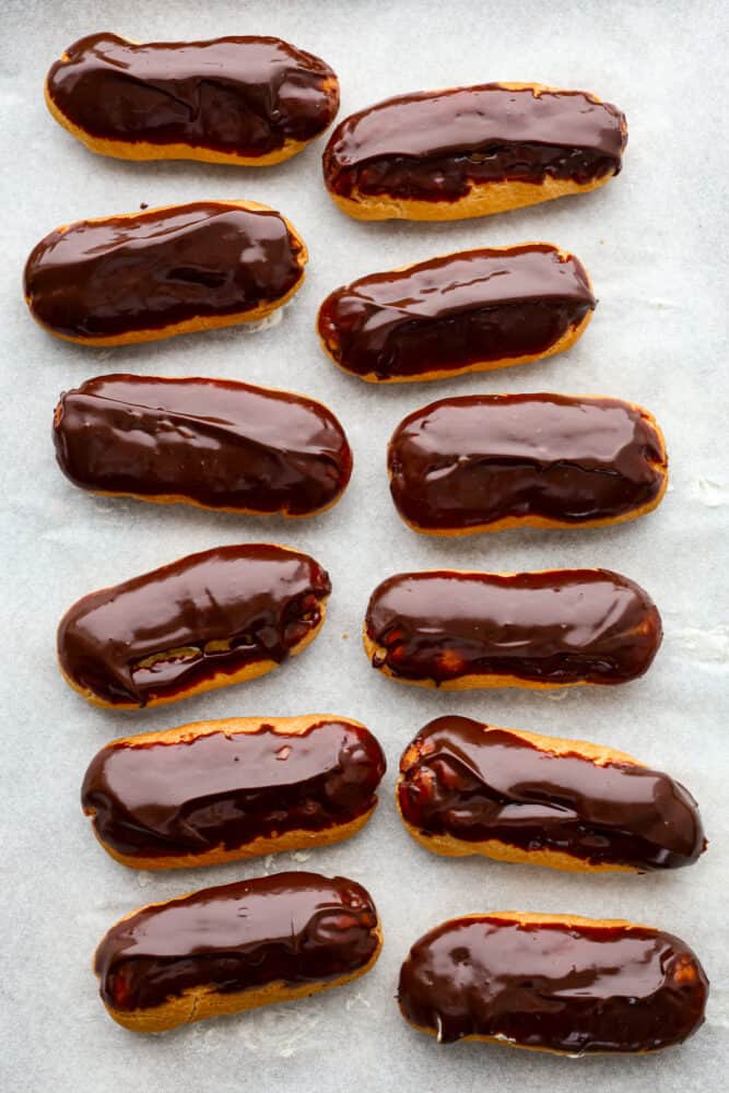 Top-down view of multiple chocolate dipped eclairs.