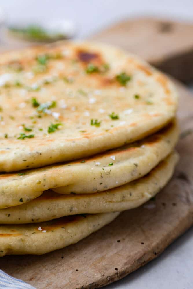 No Yeast Flatbread is a quick and easy bread recipe that you'll be making for years to come! Use it for sandwiches, gyros, pizza, and so much more. No need to wait for this bread to rise, with no yeast and cooked over the stove, it's a simple recipe that you will want to save for later. A close up of the flatbread.
